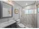 Clean bathroom featuring textured tile design, modern vanity, and glass shower at 608 Betmor Ln, Palm Harbor, FL 34683