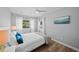 Serene bedroom with natural light, ceiling fan, and view of outdoors at 608 Betmor Ln, Palm Harbor, FL 34683