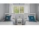 Bedroom featuring twin beds, view of yard, and bright light at 608 Betmor Ln, Palm Harbor, FL 34683
