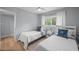 Bright bedroom with two twin beds and plenty of natural light at 608 Betmor Ln, Palm Harbor, FL 34683