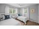Comfortable bedroom with two twin beds and natural lighting at 608 Betmor Ln, Palm Harbor, FL 34683