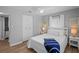 Fresh bedroom with wood floors, white linens and a closet with sliding doors at 608 Betmor Ln, Palm Harbor, FL 34683