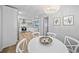 Bright dining room with chandelier lighting, a white round table, seating for six, and contemporary decor at 608 Betmor Ln, Palm Harbor, FL 34683