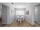 Dining room featuring a charming chandelier, large windows, seating for six, and stylish decor at 608 Betmor Ln, Palm Harbor, FL 34683