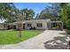 A single-story home boasts a well-kept lawn and a convenient carport at 608 Betmor Ln, Palm Harbor, FL 34683