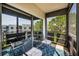 This screened balcony features relaxing seating and overlooks the building's landscaping at 6190 80Th N St # 411, St Petersburg, FL 33709