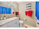 Cozy bathroom featuring a sink with vanity, toilet, and bright red accents at 6190 80Th N St # 411, St Petersburg, FL 33709