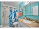 Clean bathroom featuring a shower, sink with vanity, and bright blue accents at 6190 80Th N St # 411, St Petersburg, FL 33709