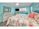 Comfortable bedroom with a coastal-themed queen bed, white dresser, and a window at 6190 80Th N St # 411, St Petersburg, FL 33709