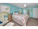 Comfortable bedroom with a queen bed, turquoise walls, and ample natural light at 6190 80Th N St # 411, St Petersburg, FL 33709