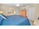 Comfortable bedroom featuring a bed, beige walls, and closet at 6190 80Th N St # 411, St Petersburg, FL 33709