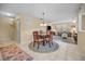 Open dining area with seating and a decorative rug, seamlessly connecting to the adjacent living space at 6190 80Th N St # 411, St Petersburg, FL 33709