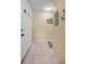 Neutral front entrance with tile flooring, white front door, and coastal decorations at 6190 80Th N St # 411, St Petersburg, FL 33709