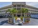 Exterior building featuring a walkway, palm trees, and tropical landscaping at 6190 80Th N St # 411, St Petersburg, FL 33709