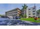 Multi-story exterior featuring palm trees and parking at 6190 80Th N St # 411, St Petersburg, FL 33709