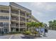 Exterior featuring balconies, walkways, and palm trees at 6190 80Th N St # 411, St Petersburg, FL 33709