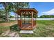 Wood gazebo surrounded by lush greenery in community park at 6190 80Th N St # 411, St Petersburg, FL 33709