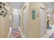 Inviting hallway with neutral walls, doors, and a colorful runner rug at 6190 80Th N St # 411, St Petersburg, FL 33709