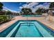 In-ground hot tub sits next to a large community pool at 6190 80Th N St # 411, St Petersburg, FL 33709
