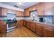 Well-lit kitchen with ample counter space, stainless steel appliances, and wood cabinets at 6190 80Th N St # 411, St Petersburg, FL 33709