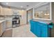 Open kitchen with stainless steel appliances, bright cabinets, and an island pass-through at 6190 80Th N St # 411, St Petersburg, FL 33709