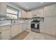 Well-lit kitchen boasts stainless steel oven, white appliances, and stylish backsplash at 6190 80Th N St # 411, St Petersburg, FL 33709