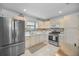 Bright kitchen features stainless steel appliances, tiled backsplash, and plenty of cabinet space at 6190 80Th N St # 411, St Petersburg, FL 33709
