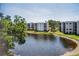 Enjoy the serene lake view from the screened balcony of this property at 6190 80Th N St # 411, St Petersburg, FL 33709