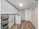 Bright laundry room featuring wood-look flooring, front-loading washer and dryer, and ample storage space with wire rack and shelving at 6190 80Th N St # 411, St Petersburg, FL 33709