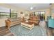Bright living room with cozy seating, decorative rug, and sliding glass doors to a balcony at 6190 80Th N St # 411, St Petersburg, FL 33709