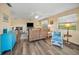 Relaxing living room featuring wood floors, plush seating, and sunny windows with beach-themed decor at 6190 80Th N St # 411, St Petersburg, FL 33709
