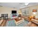 Comfortable living room with an electric fireplace, stylish furniture, and an inviting atmosphere at 6190 80Th N St # 411, St Petersburg, FL 33709
