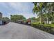 View of the covered parking available in this community featuring mature trees and landscaping at 6190 80Th N St # 411, St Petersburg, FL 33709
