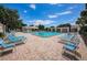 Community pool with plenty of lounge chairs for relaxing and enjoying the weather at 6190 80Th N St # 411, St Petersburg, FL 33709