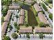 A scenic aerial view of the community showcasing lush landscaping and a serene pond at 6231 Bayside Key Dr, Tampa, FL 33615