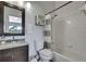 This cozy bathroom features a shower and tub combo with a shower curtain and a dark vanity at 6231 Bayside Key Dr, Tampa, FL 33615