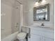 Bright bathroom with a shower-tub combination, modern vanity, and neutral decor at 6231 Bayside Key Dr, Tampa, FL 33615