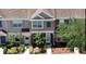 Aerial view of the front of a townhouse featuring a well-maintained lawn and landscaping at 6231 Bayside Key Dr, Tampa, FL 33615