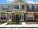 Charming townhome featuring colorful shutters, tropical landscaping, and a welcoming entrance at 6231 Bayside Key Dr, Tampa, FL 33615