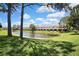 Exterior view showcasing the building and tranquil pond views, surrounded by lush landscaping at 6231 Bayside Key Dr, Tampa, FL 33615