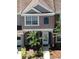 A close-up of the townhome's front exterior with a small palm tree in the yard at 6231 Bayside Key Dr, Tampa, FL 33615