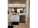 Functional kitchen with stainless steel dishwasher and pass-through to living space at 6231 Bayside Key Dr, Tampa, FL 33615