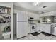 Bright kitchen features white appliances, ample storage, and convenient layout at 6231 Bayside Key Dr, Tampa, FL 33615
