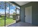 Screened lanai with tile flooring, providing a relaxing outdoor space with views of the surrounding landscape at 6231 Bayside Key Dr, Tampa, FL 33615