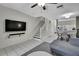Living room with tile flooring, media center, view of staircase, and open to dining area at 6231 Bayside Key Dr, Tampa, FL 33615
