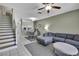 Spacious living room open to the dining area, with tile flooring, ceiling fan, and sliding glass doors at 6231 Bayside Key Dr, Tampa, FL 33615