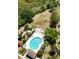 Aerial view of a pristine community pool surrounded by mature trees and ample lounging space at 6231 Bayside Key Dr, Tampa, FL 33615