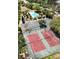 Aerial view of community tennis courts and pool area, surrounded by lush landscaping at 6231 Bayside Key Dr, Tampa, FL 33615