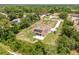 A beautiful single-story home with a pool and solar panels surrounded by lush greenery and a long driveway at 7206 River Country Dr, Weeki Wachee, FL 34607