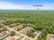 Aerial view of a single-story home near Hernando Beach, surrounded by a lush, green landscape at 7206 River Country Dr, Weeki Wachee, FL 34607